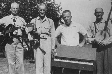 Bob Walters, second from left, poses with a group of musicians including Bob Christeson (standing behind his melodeon). R.P. Christeson collection photo.