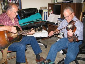 Roger Williams plays fiddle in his living room with guitar backup played by Ed McKinney
