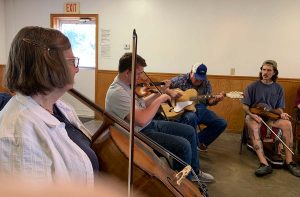 Musicians play fiddle, cello and guitar at the Hallsville jam session